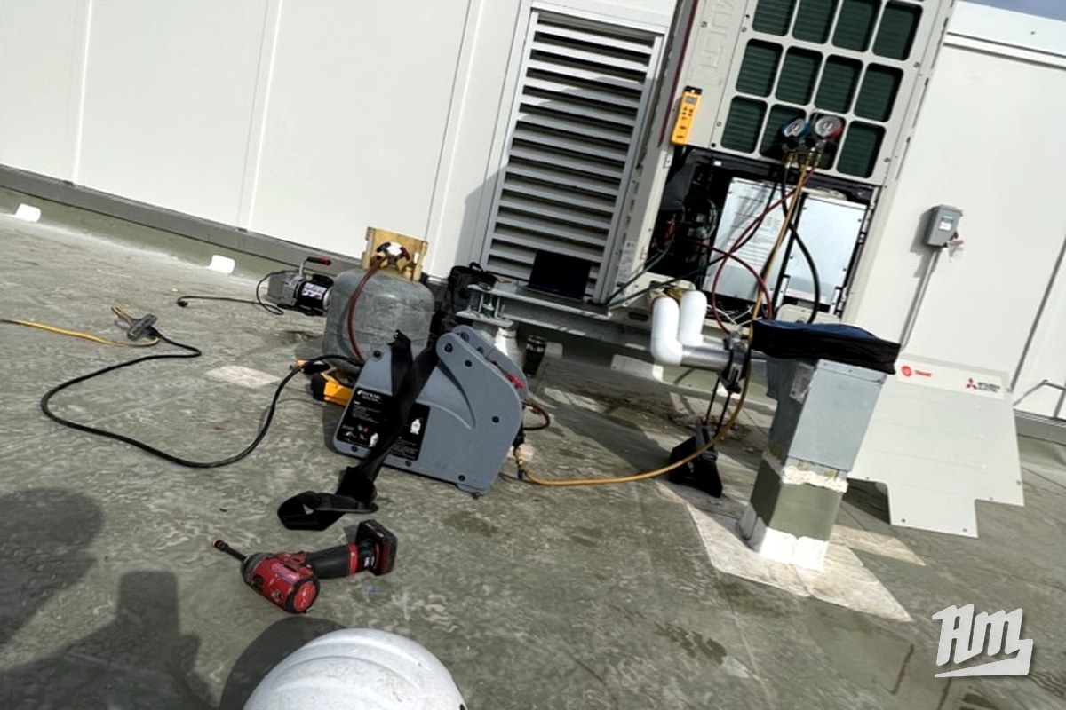 Mitsubishi VRF commissioning scene with hard hat